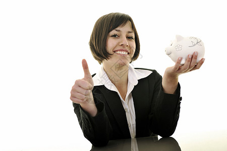 女商务人士在小猪银行投硬币办公室财富微笑退休人士成功女孩成人贷款收益图片