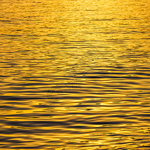 日落时金色海浪以地表背景为光亮气候花絮游艇巡航波纹波浪金子热带旅行海滩背景图片