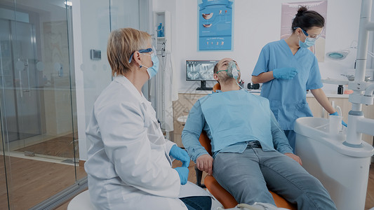 病人晕倒在路上牙医助理 在病人脸上戴上氧气面具背景