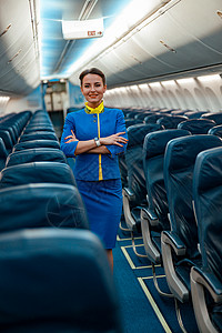 坐在飞机客机舱的慰安妇女空姐喷射乘客航程空气旅行走道工人座位成人员工背景