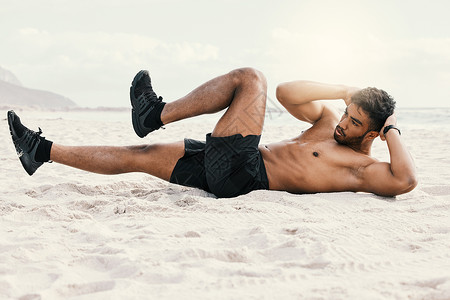 拍到一个运动的年轻人在沙滩上做曲棍球锻炼时被吓得晕头转向背景