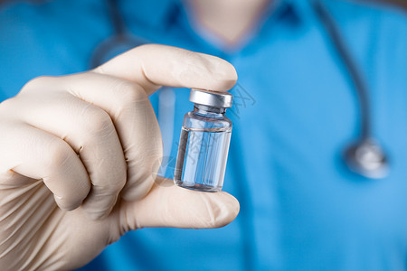 医生持有抗冠状病毒疫苗的毒物免疫医院科学疫苗安瓿剂量药品糖尿病健康注射器背景