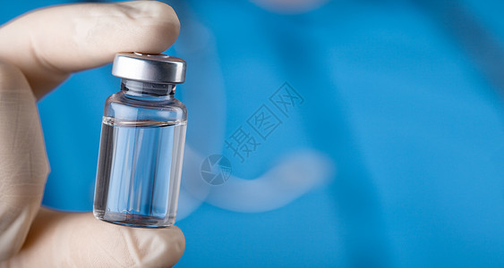 医生持有抗冠状病毒疫苗的毒物实验室流感手套注射注射器疫苗健康抗生素药剂剂量背景