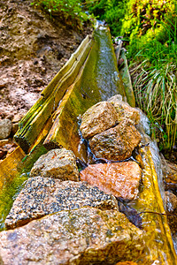 干净的冷水从木质沟里流下来高清图片