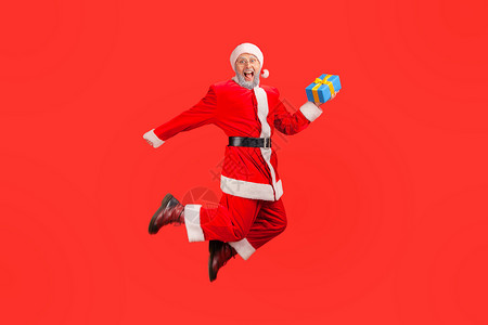 红色背景的情感圣诞老人条款新年蹦床礼物盒成功自由展示奖金热情男性优胜者背景图片