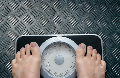 小秤体重秤上脚的顶视图 女性在控制饮食后在体重秤上称重 健康的体重 体重和脂肪减少的概念 称重机 身体质量指数或 BMI 概念背景