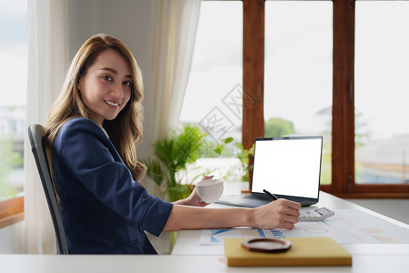 商业女商务人士分析公司的财务制度和书面文件在办公桌上背景图片