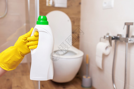 浴手套用于洗净厕所的白色瓶子模型 近身时 手拿着一瓶液体背景
