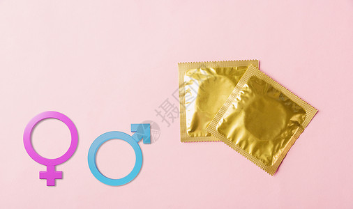 包装袋中的避孕套和男女性别标志金子女性梅毒包装男人世界怀孕安全男性药品背景图片
