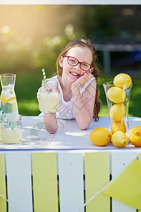 一个小女孩的肖像 从她外面的摊位上卖柠檬汁高清图片