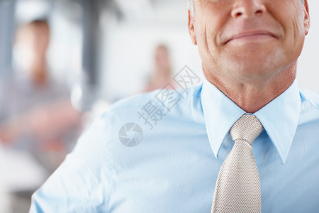气势磅礴的人物——领导力 一位高级商务人士微笑着打着领带的裁剪图像背景图片