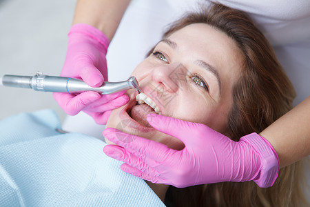 牙科诊所的孕妇保健女士口腔科保险卫生牙齿治疗考试微笑病人背景图片