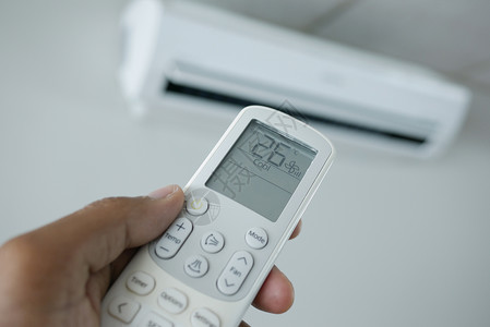 控制温度近距离接近手握空气状态遥控器的人程序护发素房间控制操作温度力量活力背景