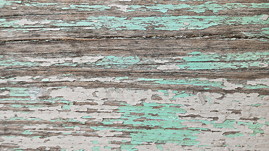 木板分层木质表面有碎裂的多色糊涂料背景