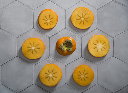 切瓷砖双西蒙切片位于灰色背景上 以六边形瓷砖的形式出现产品水果热带异国情调季节橙子小吃饮食柿子背景