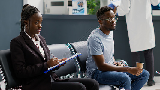 信访接待站坐在等候区的非洲美国人在临床接待站就座的病人背景
