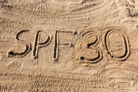 护理带字素材太阳保护系数30概念 在海滩上写了SPF30字背景