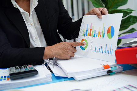 销量统计图从事商业工作和分析的妇女在办公室中使用统计图分析营销团队文档互联网文员经济报告数据项目生长背景