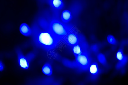 闪亮的蓝色灯光 斑点 微光 黑暗的 发光的 寒冷的 圣诞节 色调背景图片