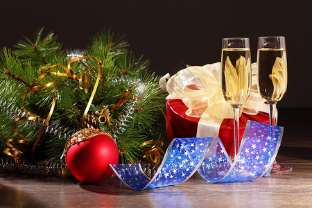 新年派对上香槟的玻璃杯 液体 金的 瓶子 圣诞快乐 弓图片