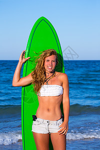 在海滩上持冲浪滑板的金黄色冲浪少女女孩 波浪图片