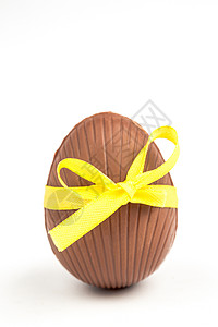 巧克力东面蛋 糖果 复活节彩蛋 假期 甜的 弓 黄色的背景图片