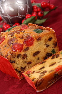 水果蛋糕切片 蜜饯 圣诞蛋糕 摄影 甜食 盘子 坚果背景图片