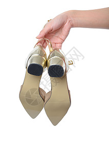 妇女手握金金金高跟鞋 美丽的 时尚 奢华 美丽 配饰背景图片