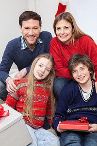 庆祝圣诞节的一家人快乐 儿子 沙发 孩子们 相机 展示背景图片