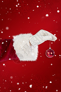 圣塔手的复合图象 握着一个圣诞灯泡 圣诞节 雪花背景图片