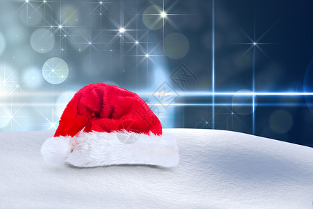 雪上圣塔帽的合成图象 假期 喜庆 星星 圣诞帽 蓝色的背景图片