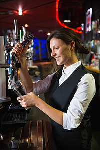 欢乐酒吧女招待拉一品脱啤酒 职业 马甲 啤酒泵背景图片