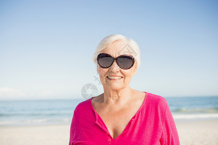 微笑的老女人的肖像 太阳镜 海岸线 女性 户外 高级的背景图片