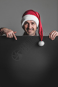 戴圣诞老人帽子的人 手指 微笑 横幅 海报 广告牌背景图片