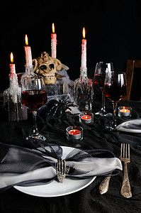 定语万圣节的餐桌设置 晚餐聚会 餐巾 手 眼镜 假期 蜡烛背景