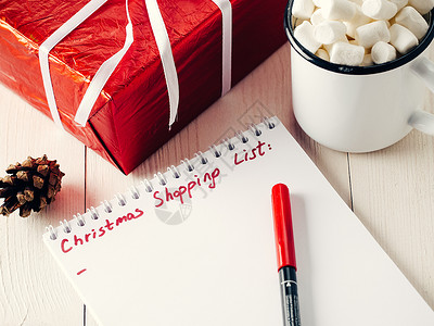 圣诞礼品购物规划清单 棉花糖 写 桌子 店铺 去做背景图片