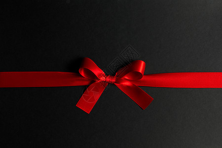 黑色上红礼弓 丝带 闪亮的 装饰品 华丽的 生日 黑色的 庆典背景图片