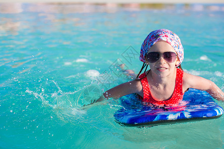 在松绿海冲浪板上可爱的小女孩 喜悦 冲浪者 蓝色的图片