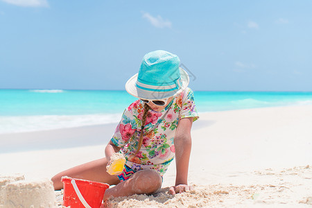 可爱沙堡在热带度假期间玩沙滩玩具的可爱小女孩 热带假期 幸福 沙堡背景