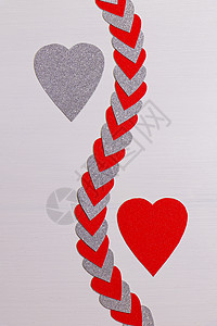 红色和银色的心与带纹理的白色心串分开背景图片