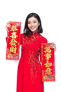 一位美丽的亚洲妇女穿着传统节服Ao Dai Tet节日 月经新年的肖像 问候语 文化背景图片