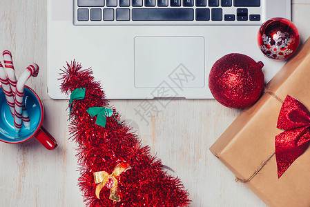 平铺的圣诞礼物 笔记本电脑在白木背景上 季节性的背景图片