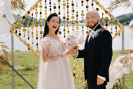 婚礼仪式期间在拱门附近的一对幸福的结婚情侣 浪漫高清图片