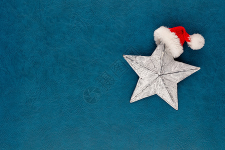 圣诞明星 圣塔帽装饰品 蓝底的圣诞明星 星星背景图片