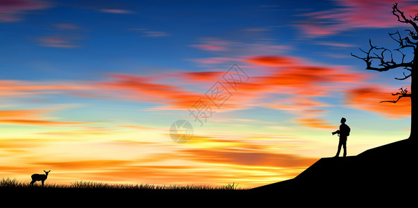 夕阳下的草地夕阳下的摄影者设计图片