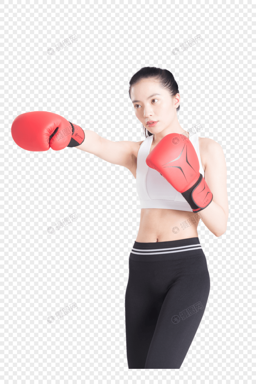 戴着拳击手套打拳出拳的年轻运动女性图片