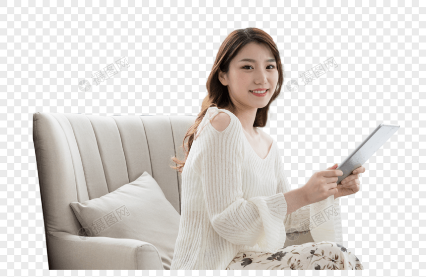 年轻女性在卧室放松看平板电脑图片