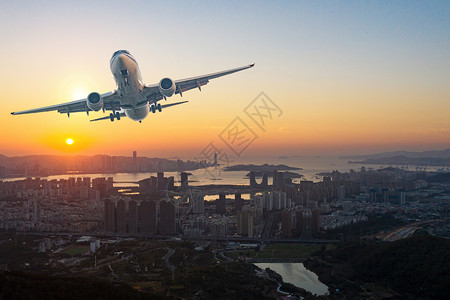 陆地上空的地平线城市上空的飞机设计图片