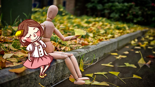秋天银杏树下的人偶背景图片