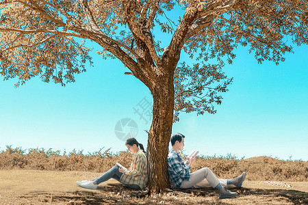 靠着树看书的人世界读书日设计图片